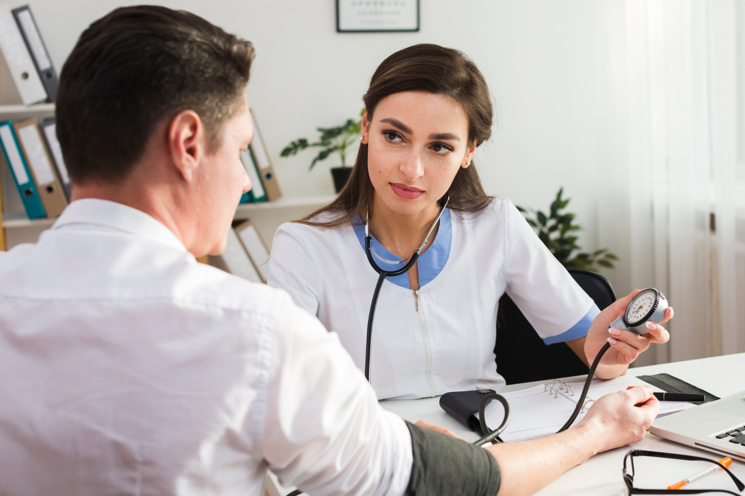 Doctor consulting patient during routine health screening appointment