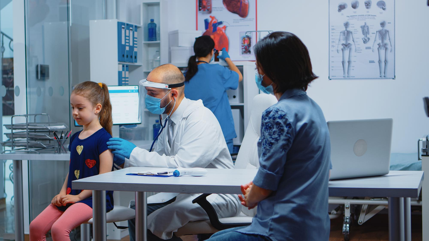 Pediatric doctor examining a child during a clinic visit