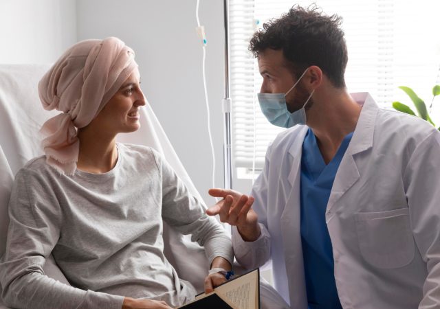 Healthcare assistant caring for a leukemia patient
