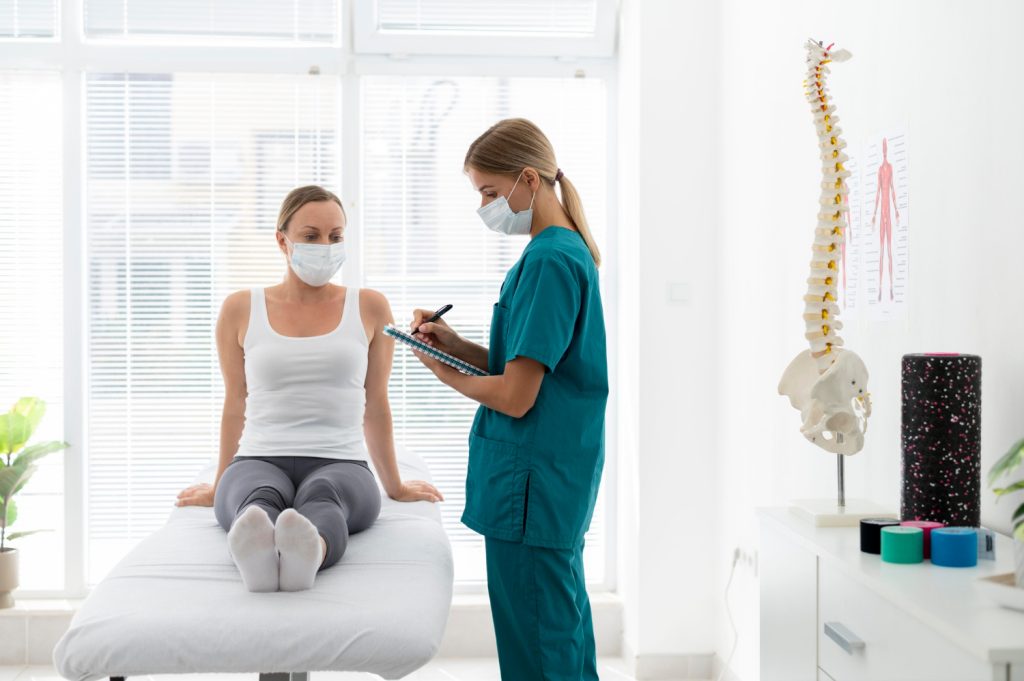 Physiotherapist helping patient with back problems