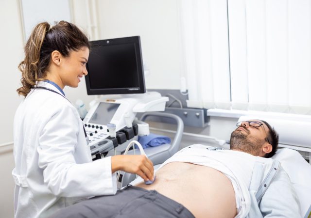 Doctor performing an abdominal diagnostic examination