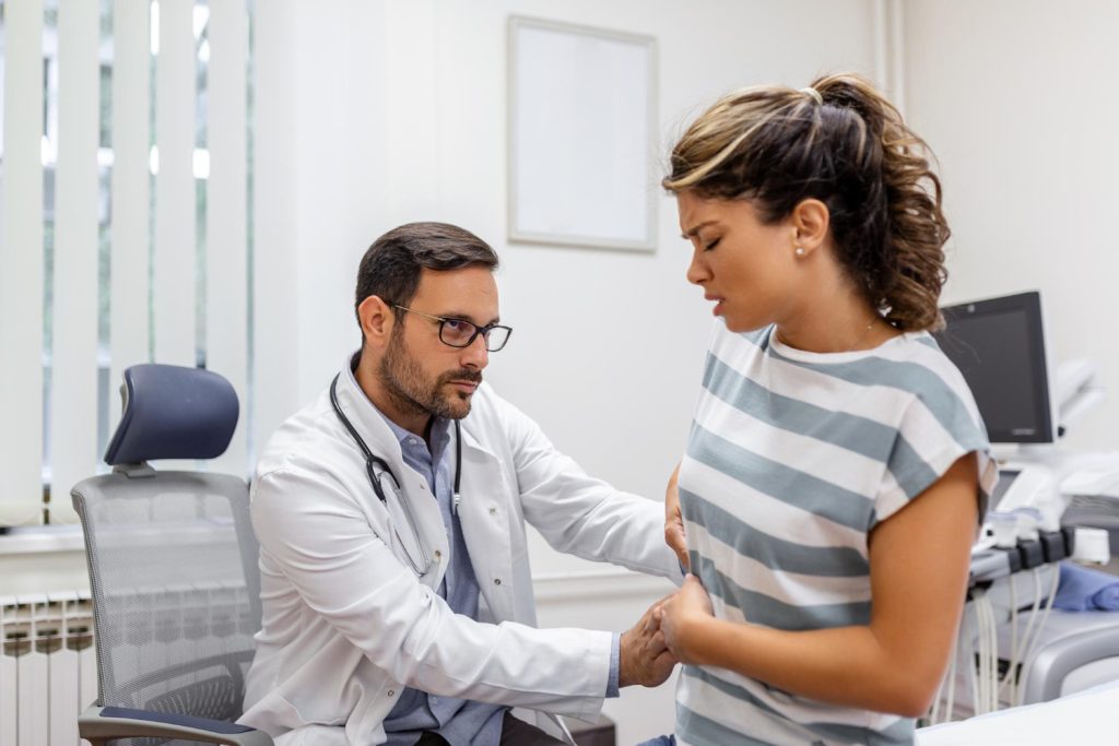 Patient discussing symptoms with doctor before an endoscopy