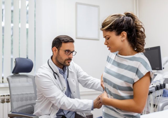 Patient discussing symptoms with doctor before an endoscopy